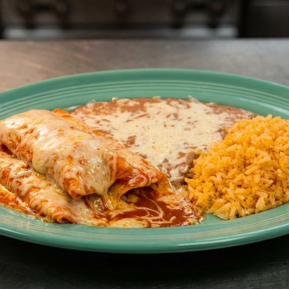 Two cheesy enchiladas, refried beans, and orange rice on a teal plate.